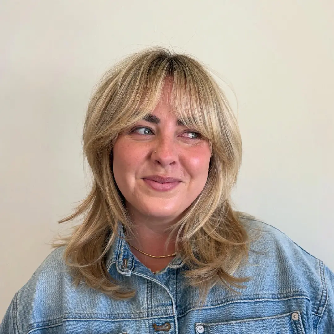 Curtain Bangs on Blonde Layered Shag with Retro Vibes