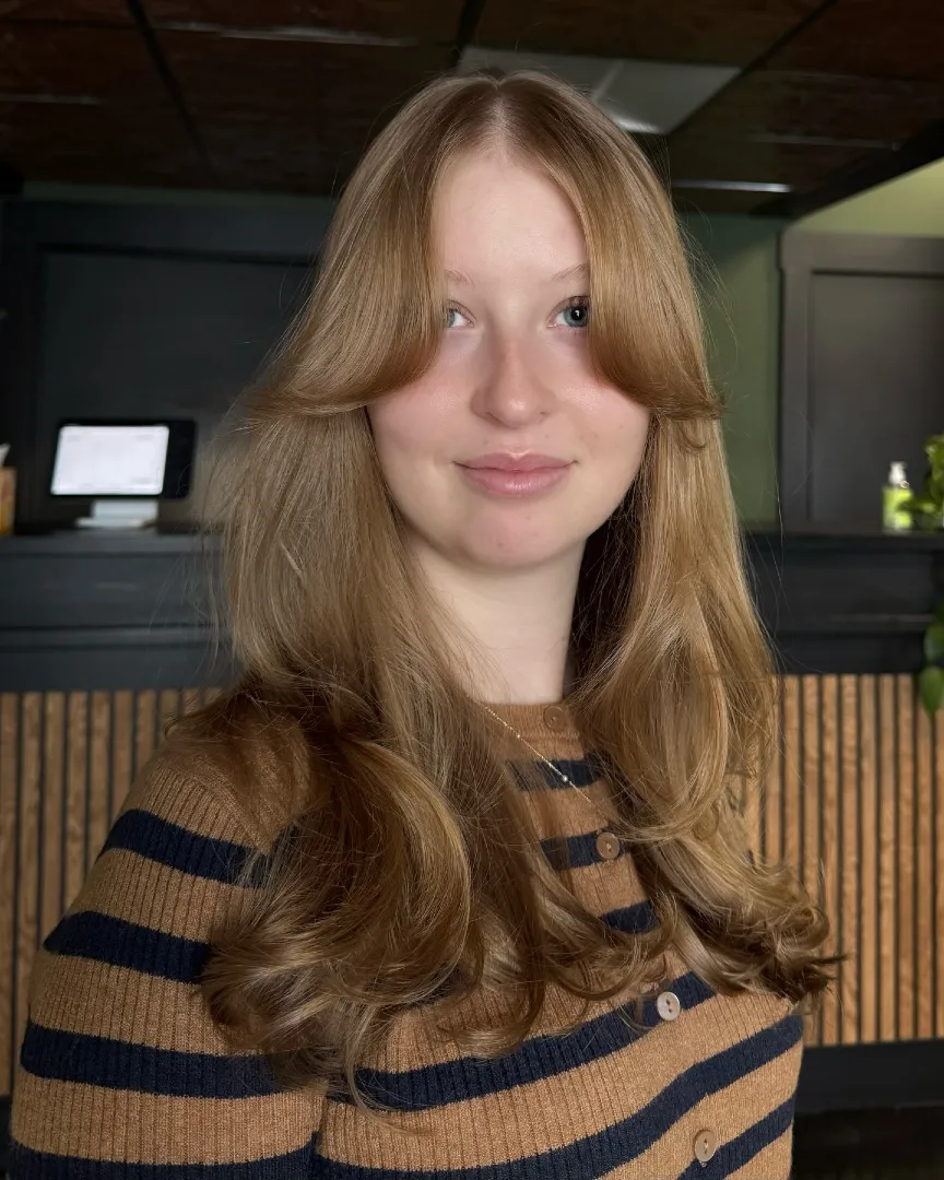 Curtain Bangs on Long Strawberry Blonde Hair with Curled Ends