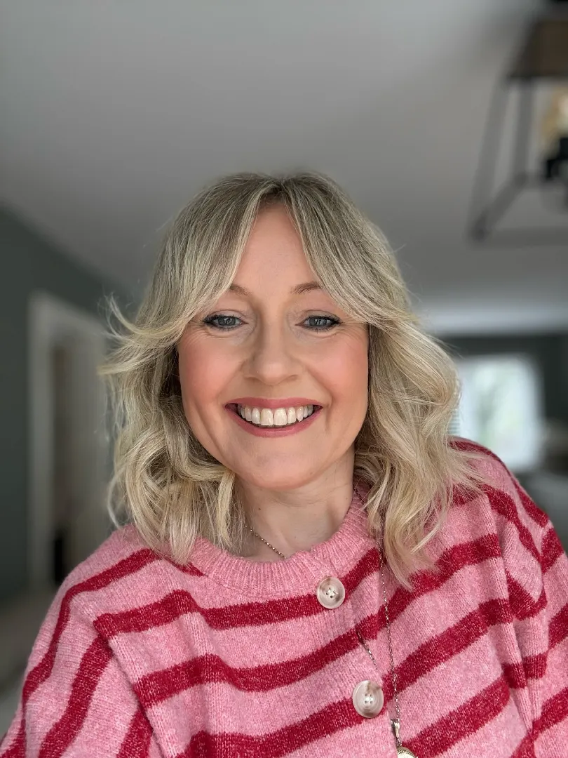 Curtain Bangs on Medium Ash Blonde Hair with Soft Waves