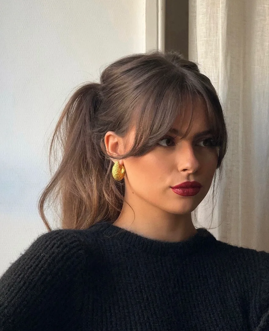 Curtain Bangs with a Messy Half-Up Ponytail