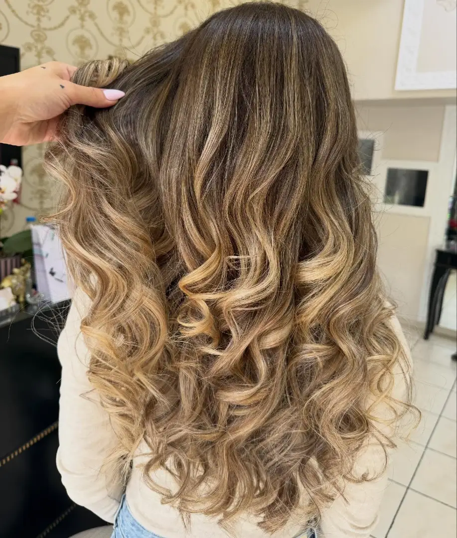 Dark Brunette Balayage with Warm Blonde Curly Ends