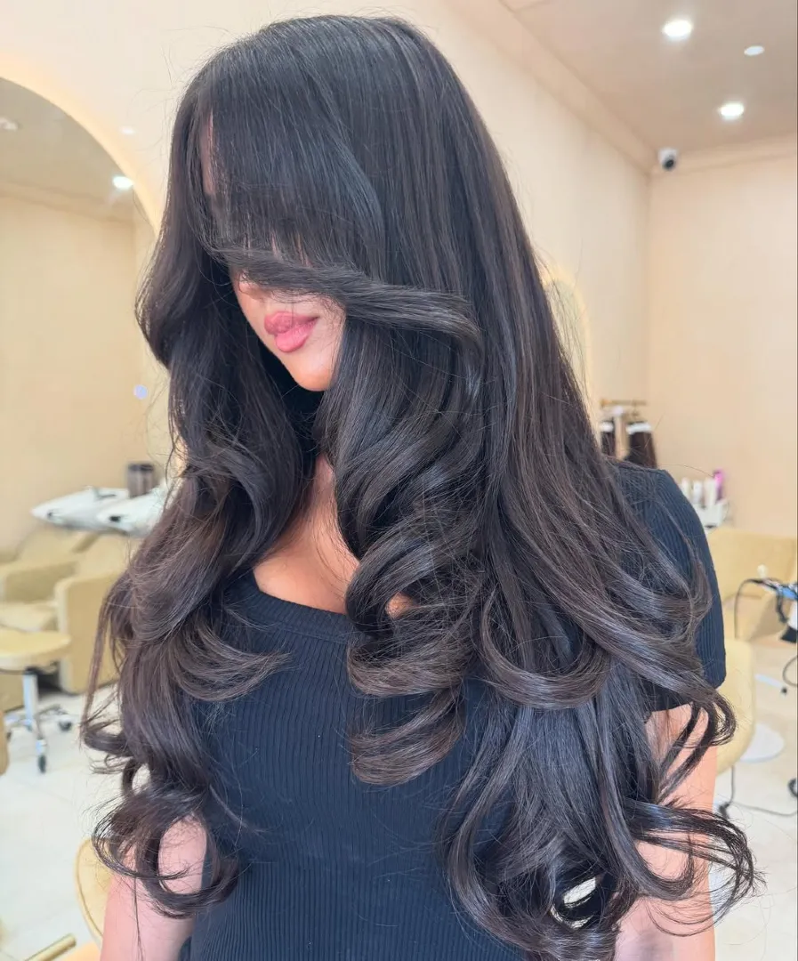 Dark Espresso Layered Hair with Curtain Bangs and Cascading Curls