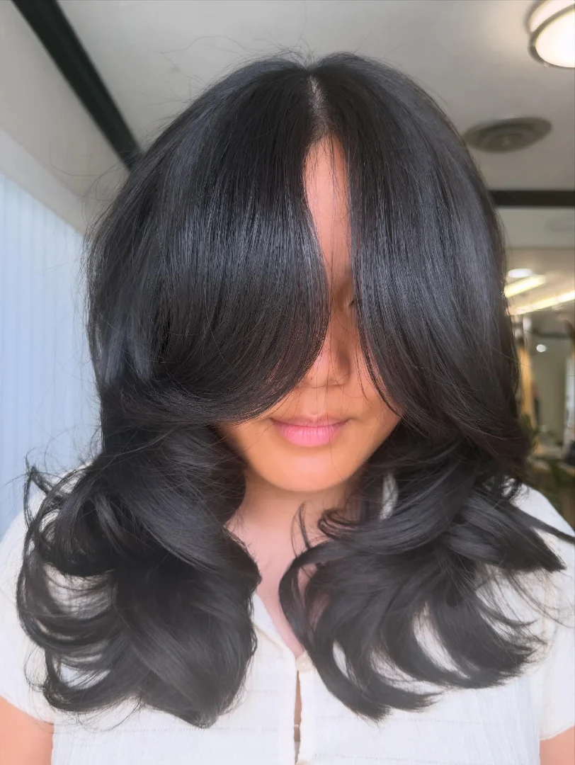 Dramatic Curtain Bangs on Dark Voluminous Blowout