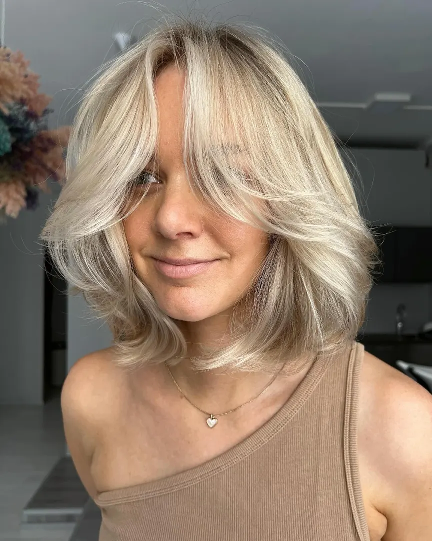 Flowy Blonde Layered Bob with Curtain Bangs