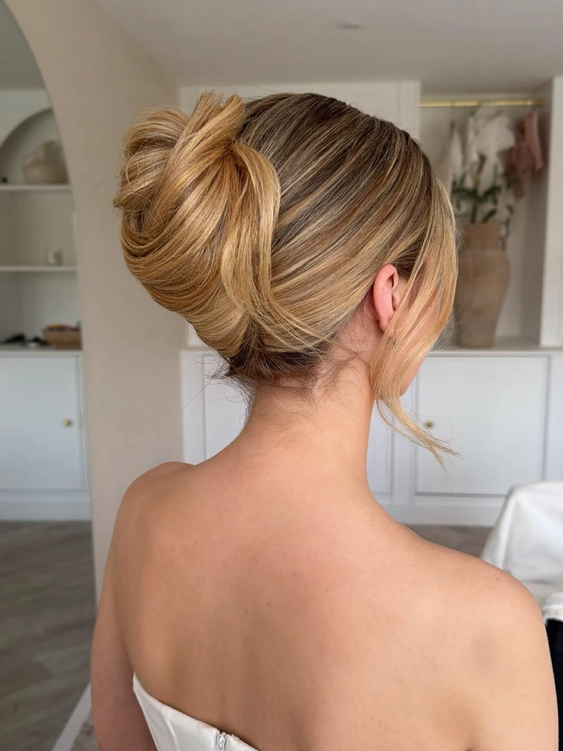 High Folded Bun with Wispy Ends