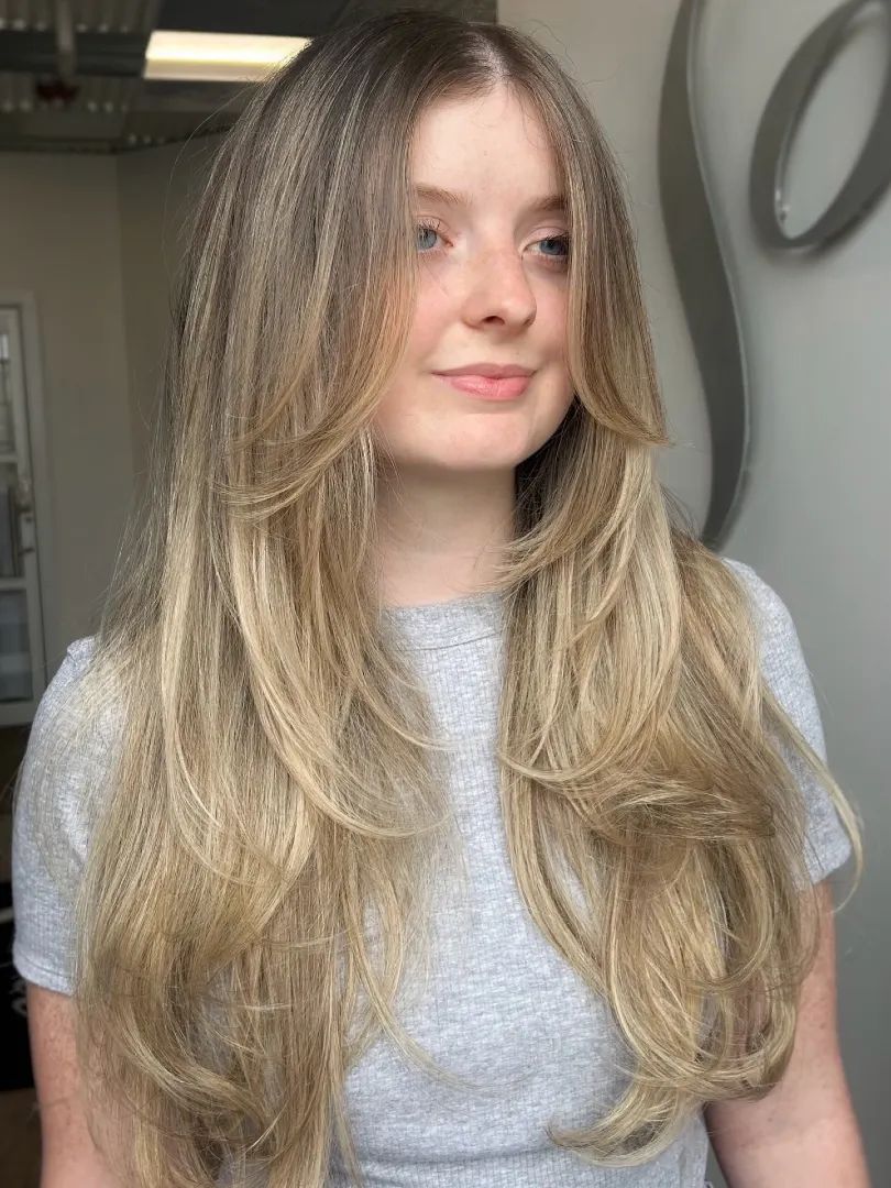Sandy Blonde Long Layers with Curtain Bangs