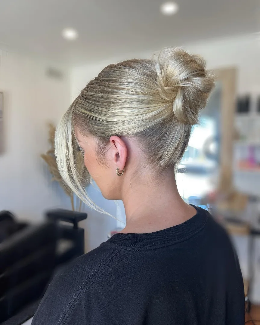 Sleek Blonde Top Knot with Flowing Side Panels