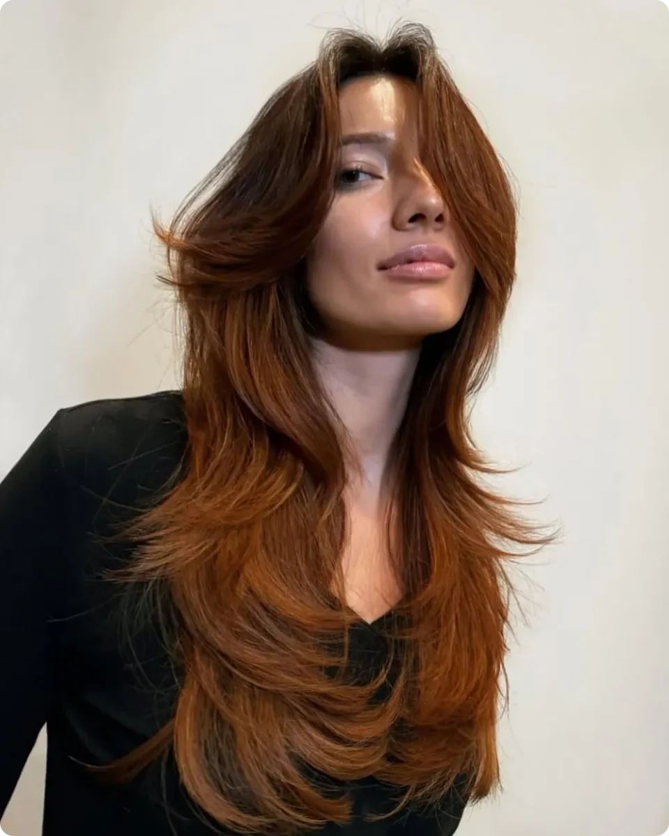Auburn butterfly layers cut in sharp tiers that fan out from the jaw to the waist