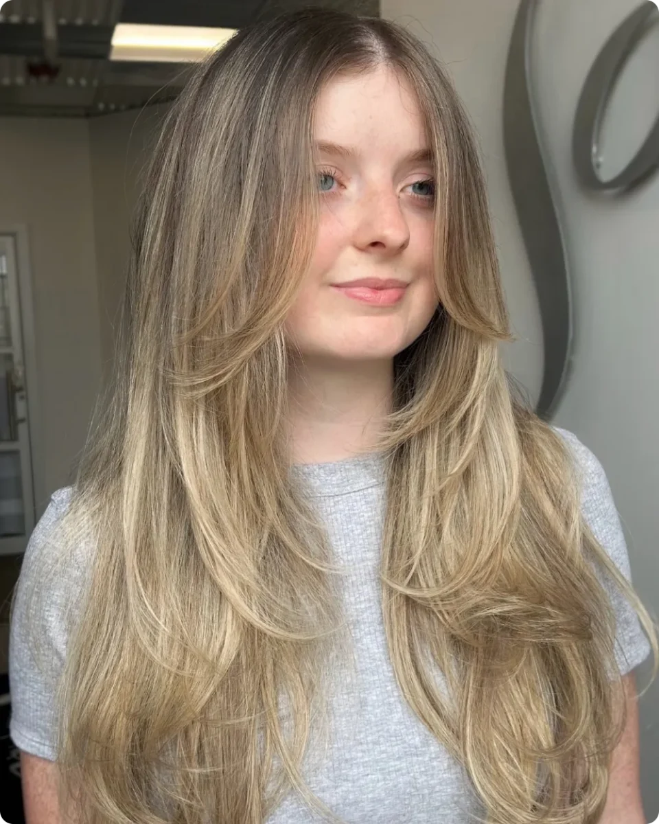 Long layers on fine blonde hair with a wide bottom line and low starting layers