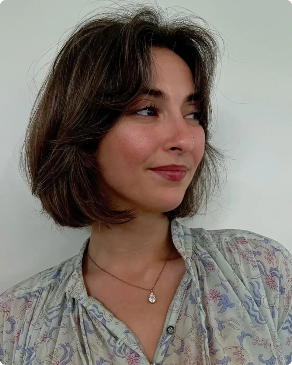 Air-dried brunette bob at chin length with soft side-swept bangs