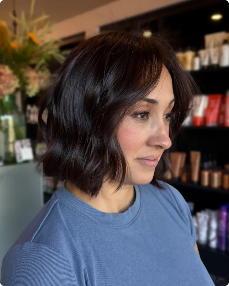 Dark brown angled bob with soft waves and longer pieces at the front