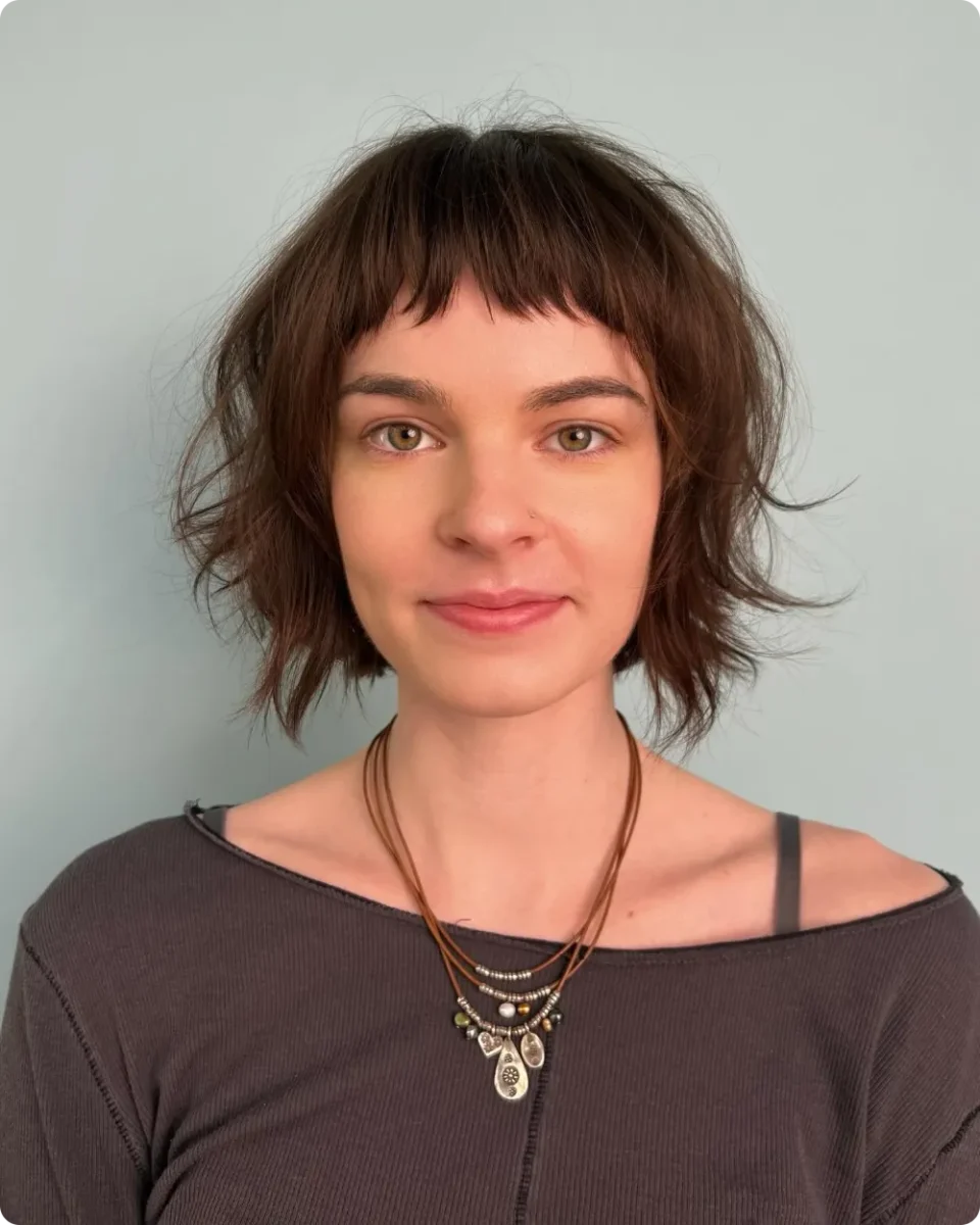 Choppy chestnut French bob with a baby fringe and roughed-up ends