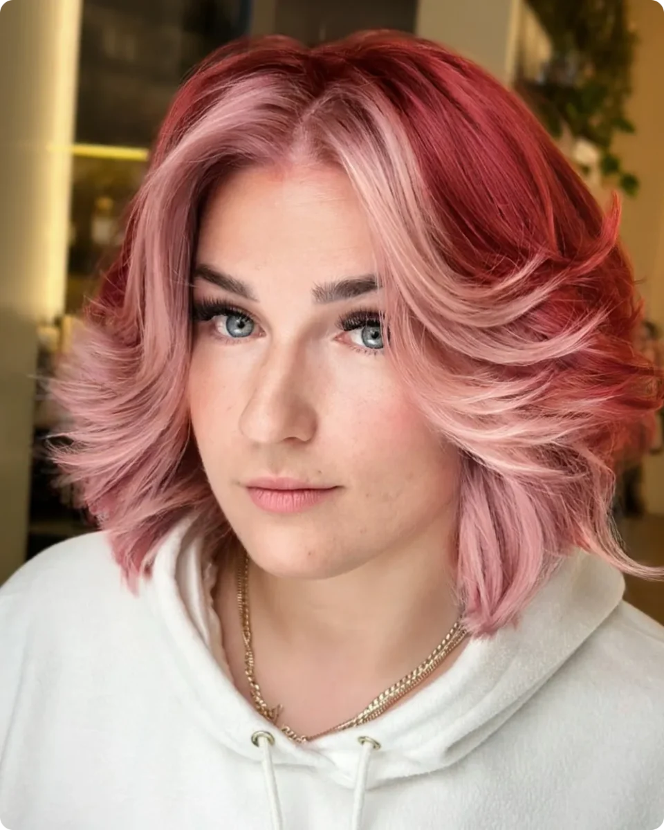 Feathered bob in two-tone pink with red underneath and pink through the top layers
