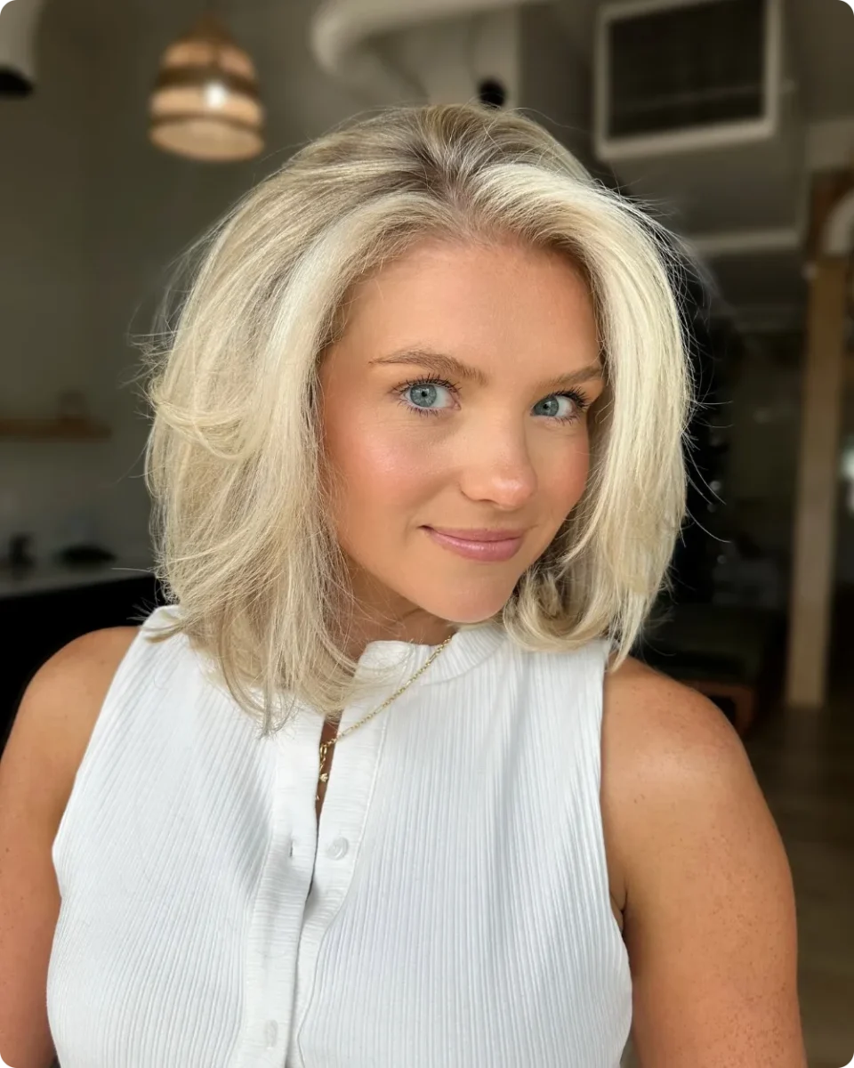 Platinum shoulder-length lob with volume through the sides and a shadow root