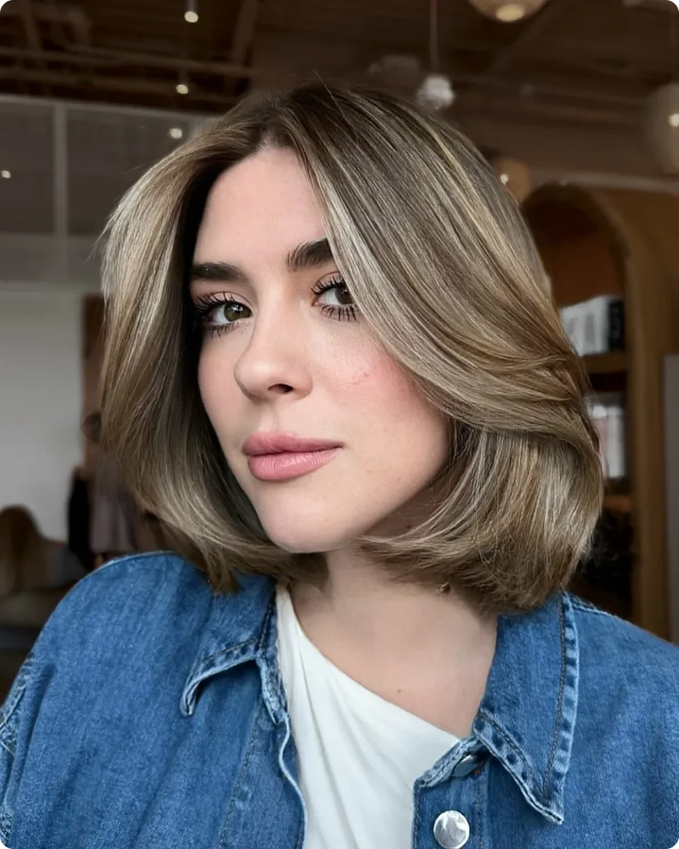 Polished bronde bob with a smooth side sweep and ends turned under