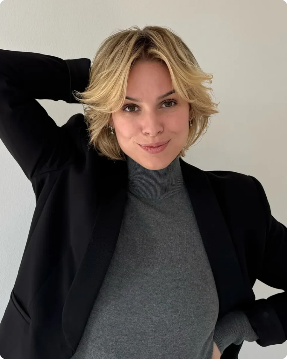 Chin-length shaggy blonde bob with flicked-out layers and soft front pieces